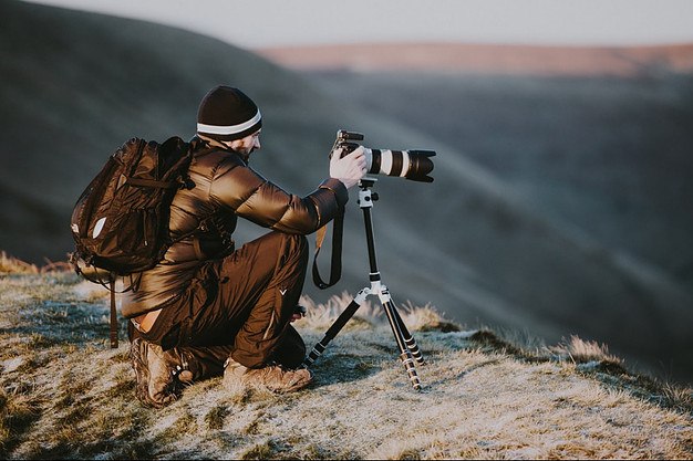 how-to-make-money-selling-photos-online-photographer-on-top-of-a-mountain